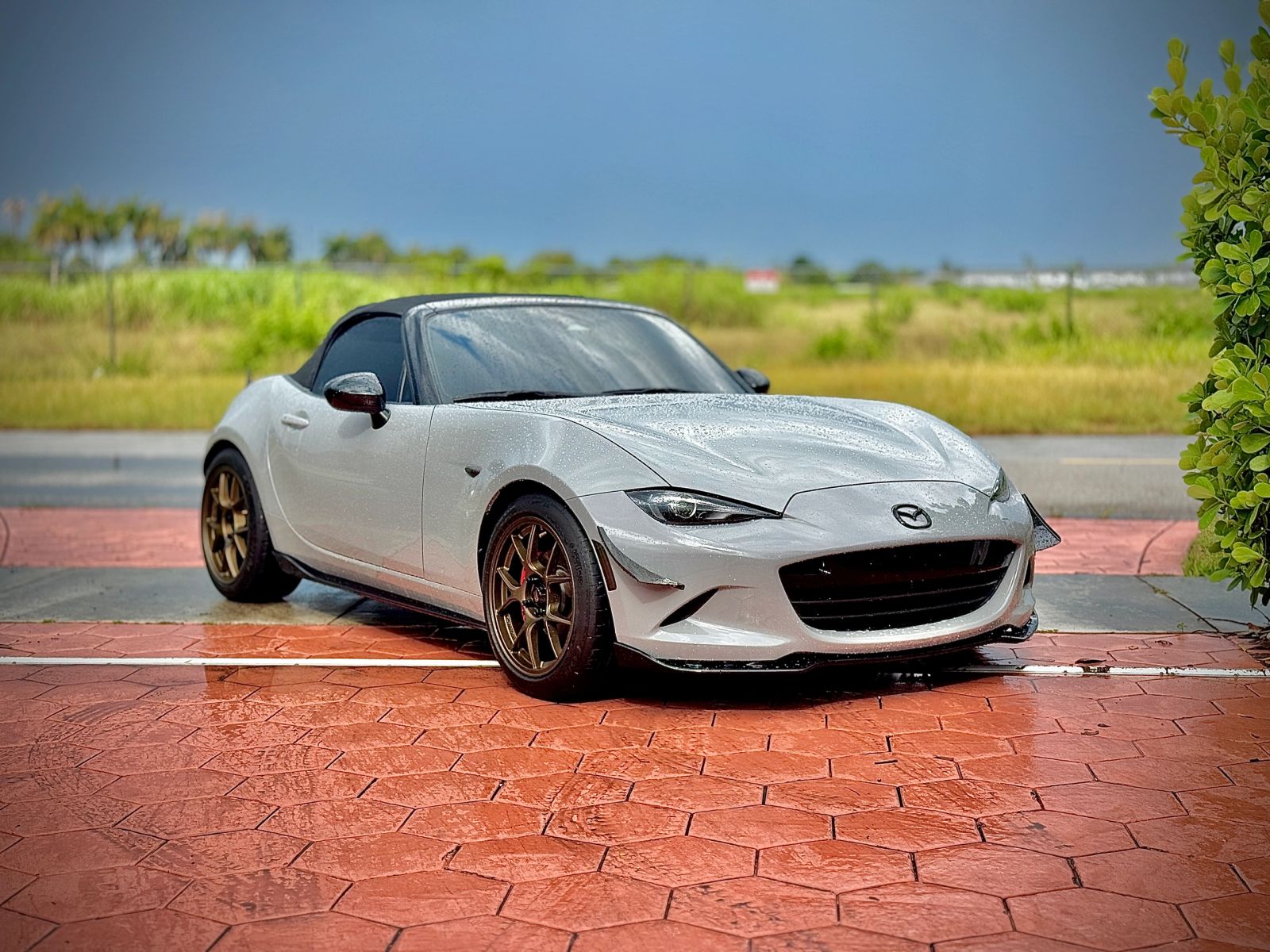 White Mazda Miata parked in the sunshine