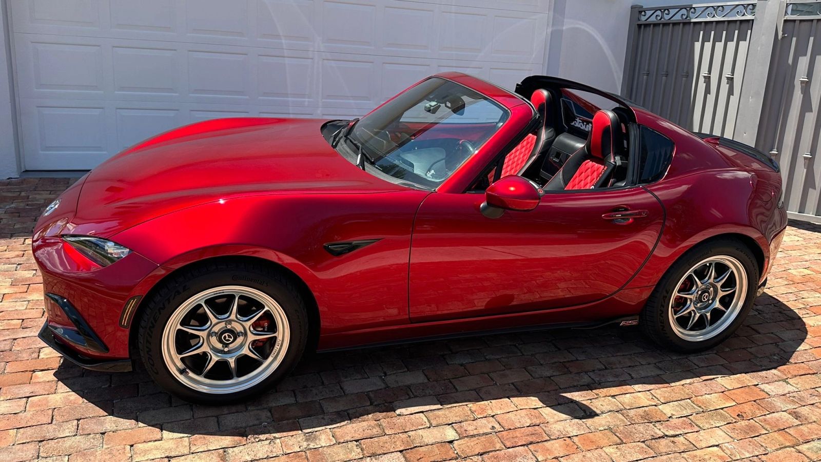 Red Mazda Miata with its top down