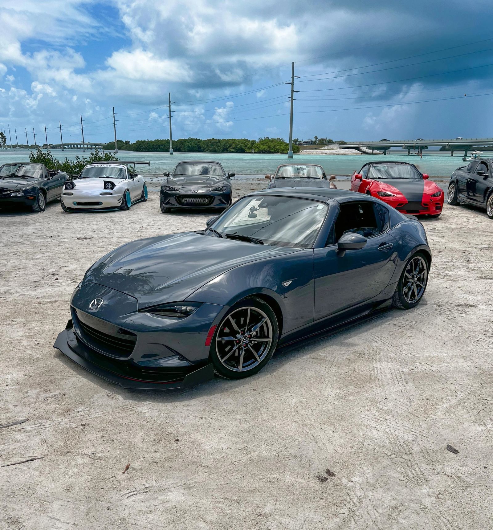 Gray Miata parked at an outdoor car gathering