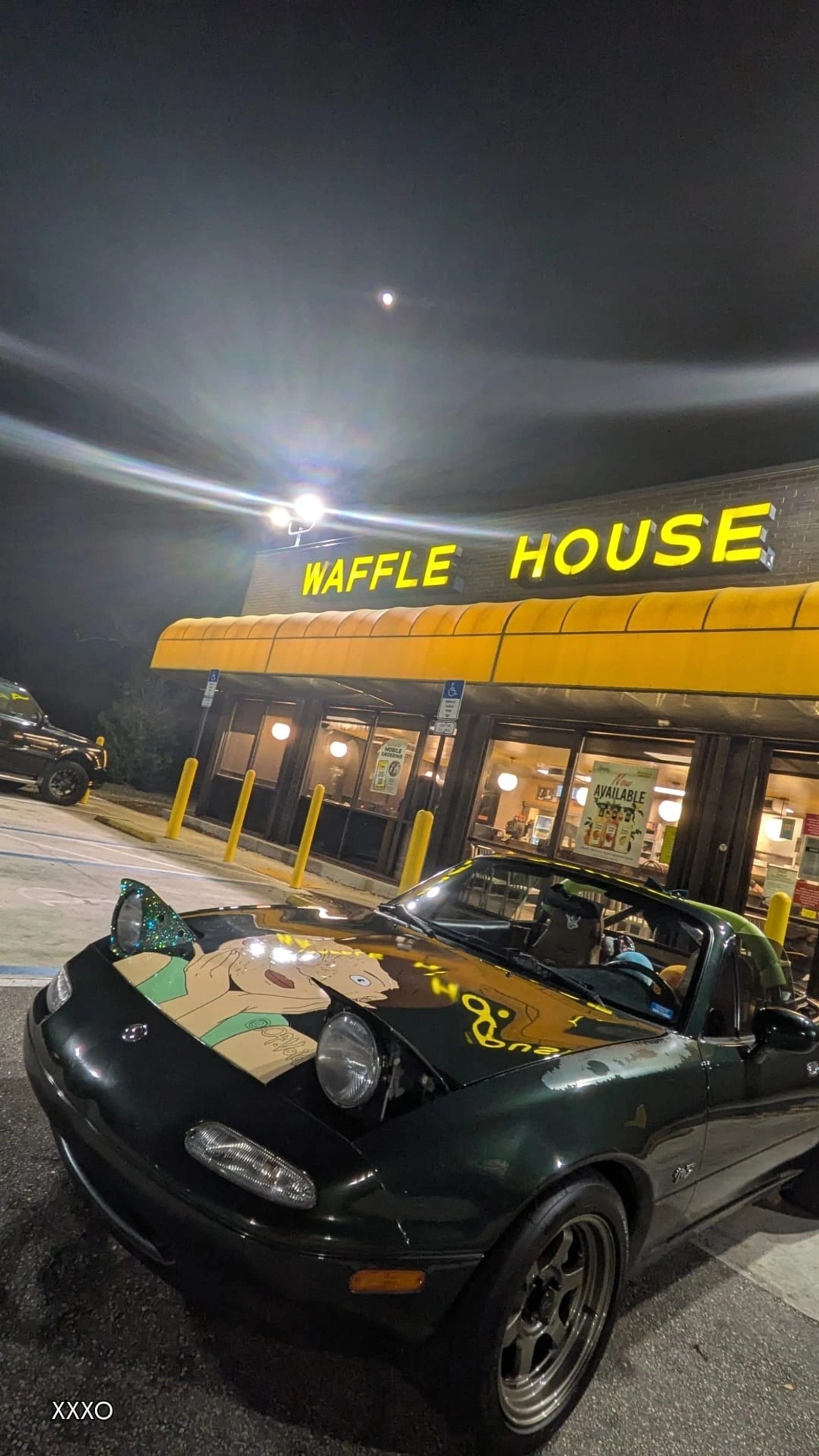 Miatas parked outside Waffle House at night